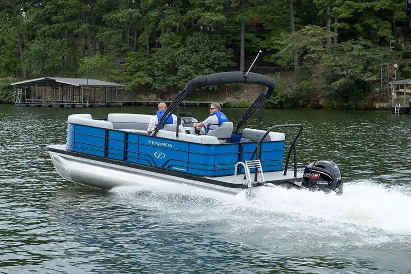 Slide: The Image of 2024 Veranda Luxury Pontoons Vista 22 RC cruising on a scenic lake. - 5