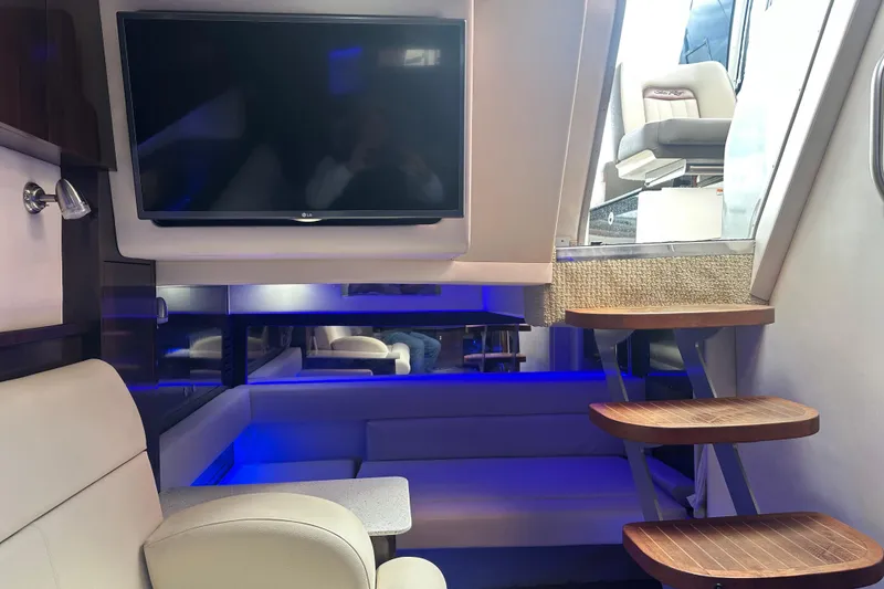 Slide: The Image of Interior of 2016 Searay Sundancer 370 yacht with TV, seating, and wooden stairs. - 10