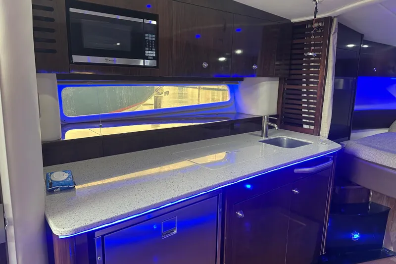 Slide: The Image of Luxurious 2016 Searay Sundancer 370 yacht interior with modern kitchen and ambient lighting. - 13