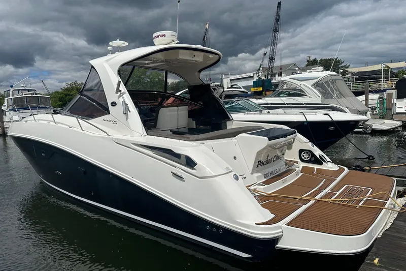 Slide: The Image of 2016 Searay Sundancer 370 yacht docked at marina under cloudy sky. - 4