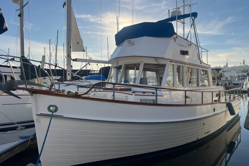 Slide: The Image of 1979 Grand Banks 36 Classic yacht docked in marina, showcasing elegant design and craftsmanship. - 11