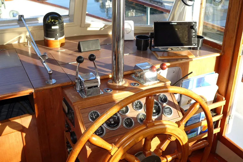 Slide: The Image of 1979 Grand Banks 36 Classic helm with wooden wheel and navigation instruments. - 16