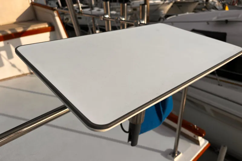 Slide: The Image of 1979 Grand Banks 36 Classic boat deck with a mounted white table. - 22