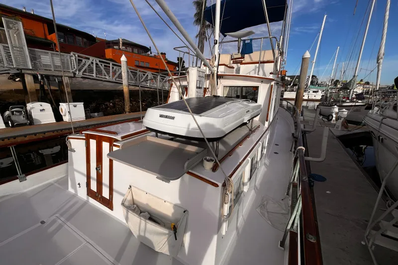 Slide: The Image of 1979 Grand Banks 36 Classic yacht docked at marina, showcasing deck and cabin features. - 29