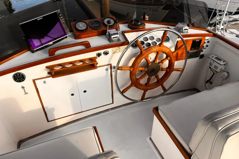 Slide: The Image of 1979 Grand Banks 36 Classic helm with wooden wheel and navigation instruments. - 31
