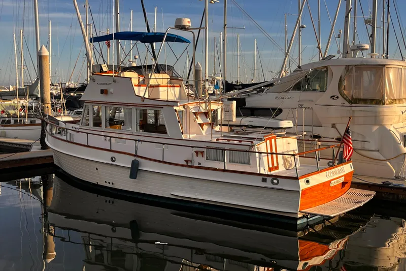 Slide: The Image of 1979 Grand Banks 36 Classic yacht docked in marina, reflecting on calm water. - 32