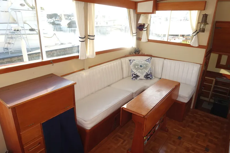 Slide: The Image of Interior of 1979 Grand Banks 36 Classic yacht with white seating and wooden furnishings. - 35