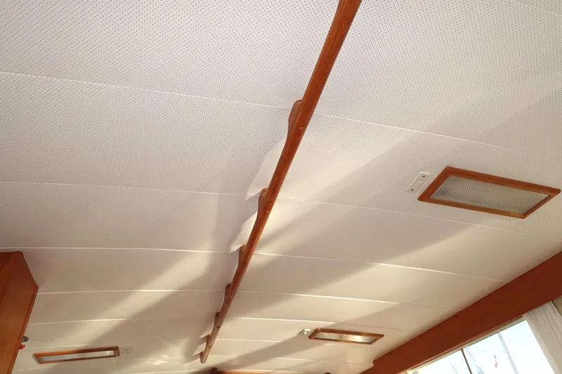 Slide: The Image of Ceiling of 1979 Grand Banks 36 Classic boat with wooden accents and lighting fixtures. - 42