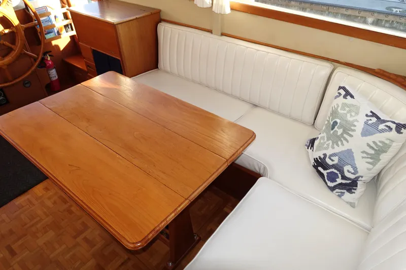 Slide: The Image of 1979 Grand Banks 36 Classic interior with wooden table and white seating. - 43
