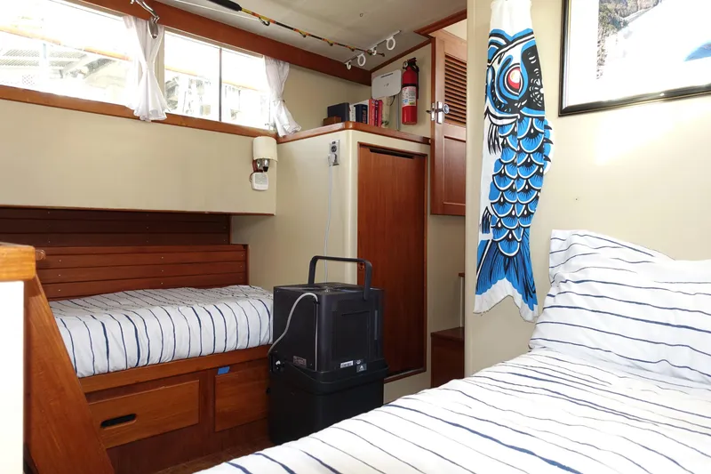 Slide: The Image of 1979 Grand Banks 36 Classic cabin interior with twin beds and nautical decor. - 46