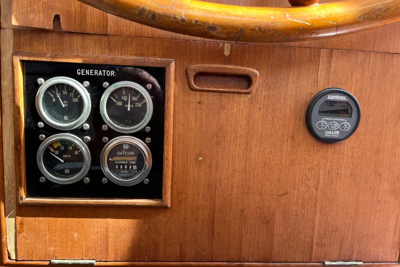 Slide: The Image of Instrument panel of a 1979 Grand Banks 36 Classic boat with gauges and battery monitor. - 60