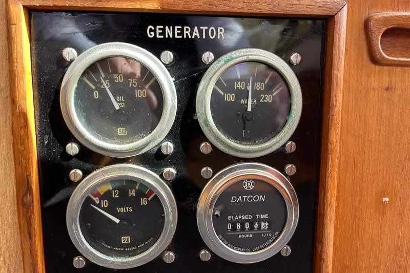 Slide: The Image of Generator gauges on a 1979 Grand Banks 36 Classic boat dashboard. - 61