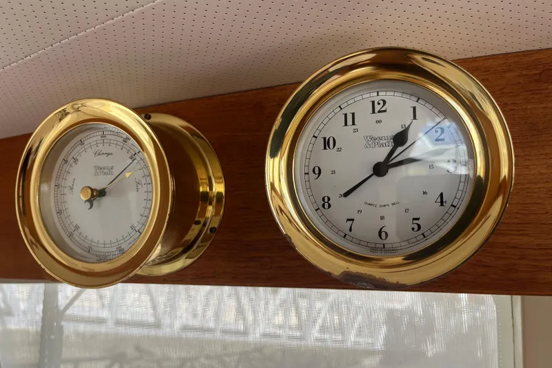 Slide: The Image of Brass clock and barometer on 1979 Grand Banks 36 Classic yacht interior. - 67