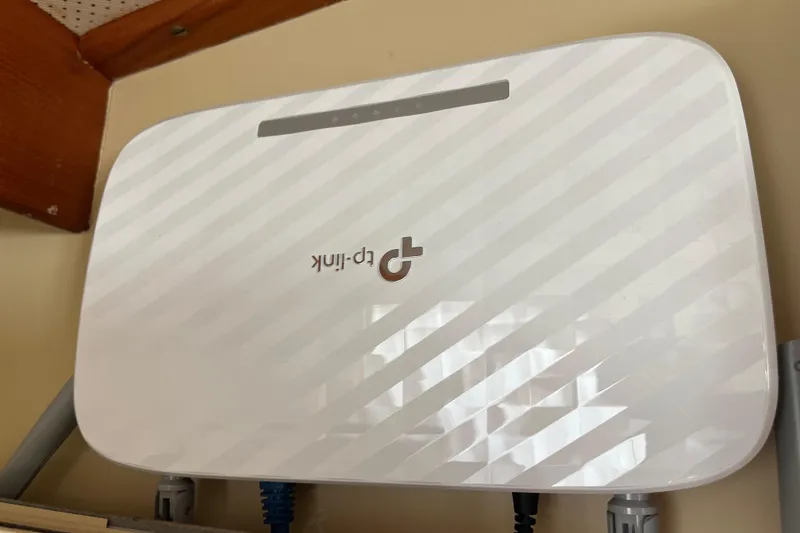 Slide: The Image of TP-Link router mounted on a wall, featuring a sleek white design. - 69