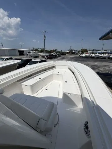 Slide: The Image of Regulator 28 boat 2026, spacious deck, sunny sky, parking lot in background. - 5