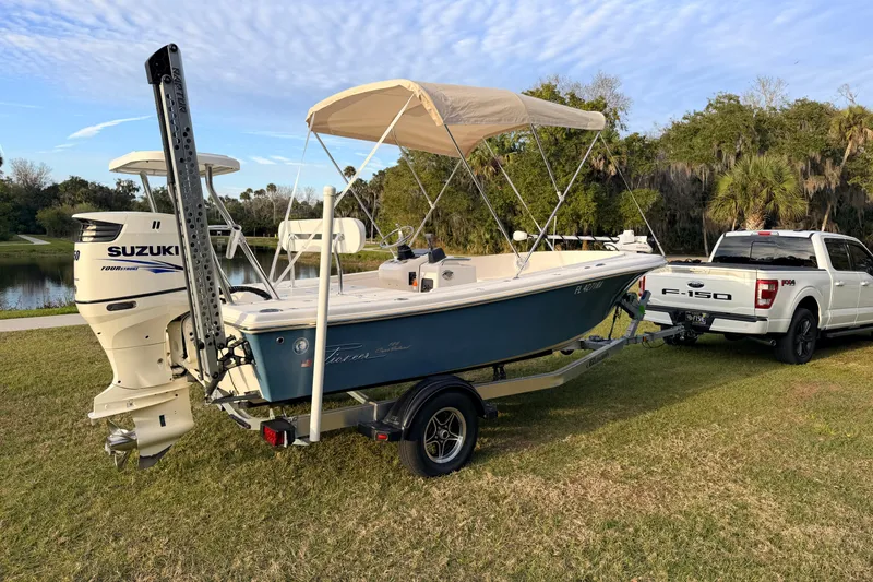 Slide: The Image of 2015 Pioneer 186 Cape Island boat on trailer, attached to a white Ford F-150 truck. - 1