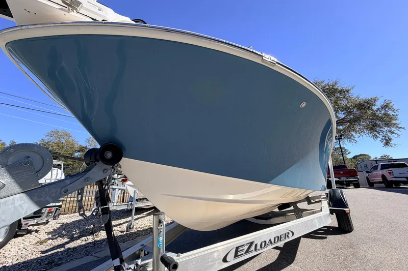 Slide: The Image of 2015 Pioneer 186 Cape Island boat on EZ Loader trailer, blue hull, sunny day. - 11