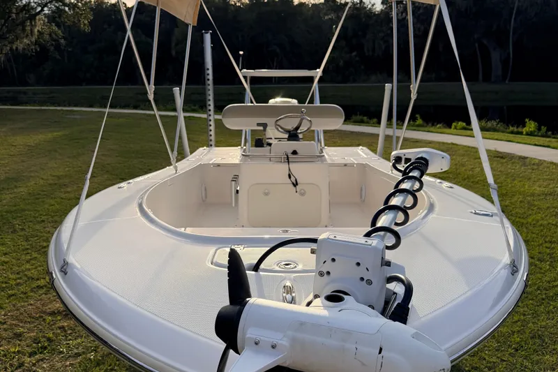 Slide: The Image of 2015 Pioneer 186 Cape Island boat on grass, showcasing deck and steering console. - 17