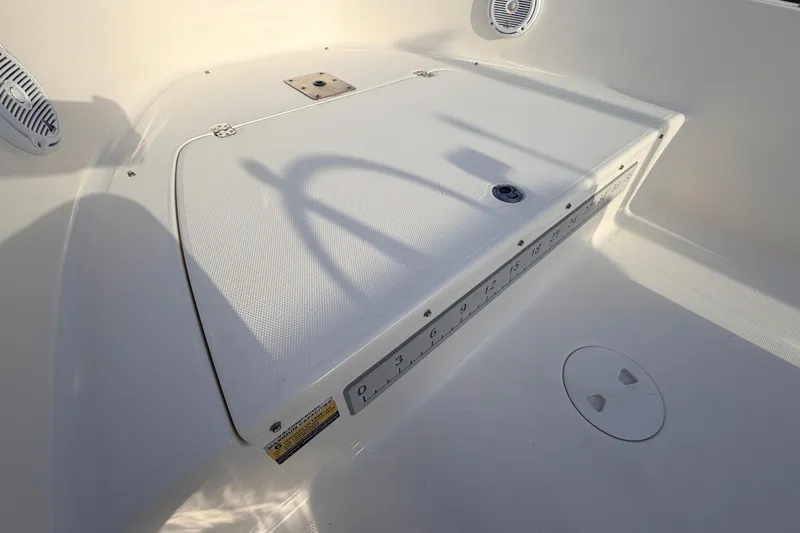 Slide: The Image of 2015 Pioneer 186 Cape Island boat deck with storage compartment and ruler. - 26