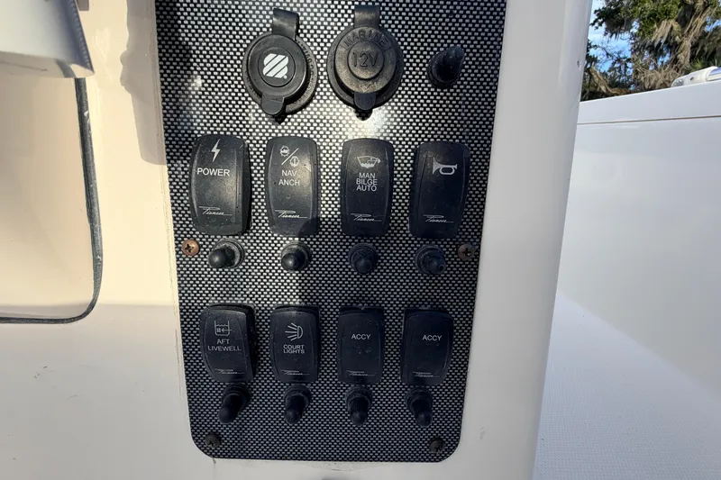 Slide: The Image of Control panel of a 2015 Pioneer 186 Cape Island boat with various switches. - 36