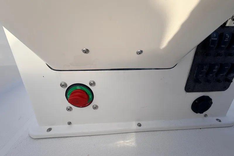 Slide: The Image of Control panel of a 2015 Pioneer 186 Cape Island boat with switches and a red-green knob. - 37