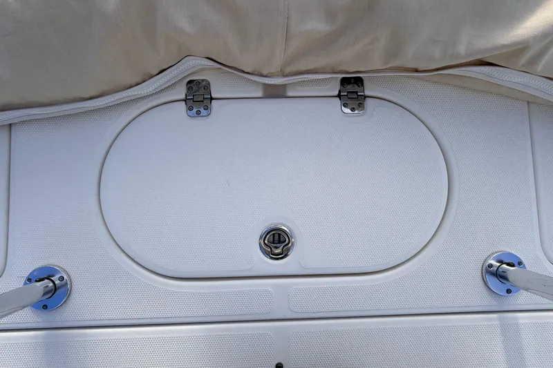Slide: The Image of Hatch cover on 2015 Pioneer 186 Cape Island boat, featuring metal hinges and latch. - 45