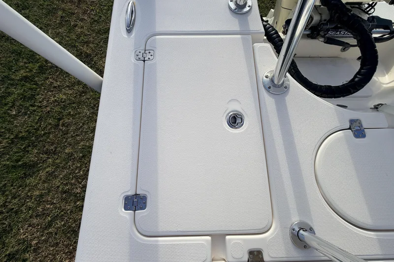 Slide: The Image of 2015 Pioneer 186 Cape Island boat deck with storage hatch and steering wheel. - 48