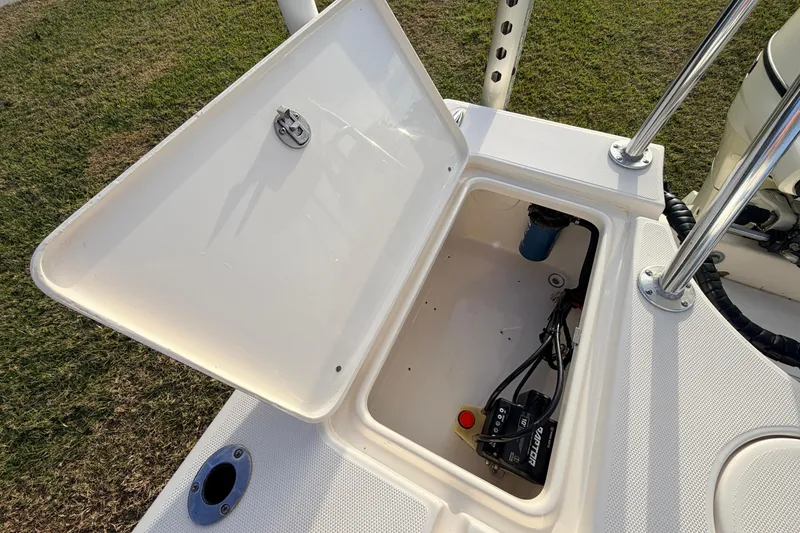 Slide: The Image of Open storage compartment on 2015 Pioneer 186 Cape Island boat, showing battery and wiring. - 49