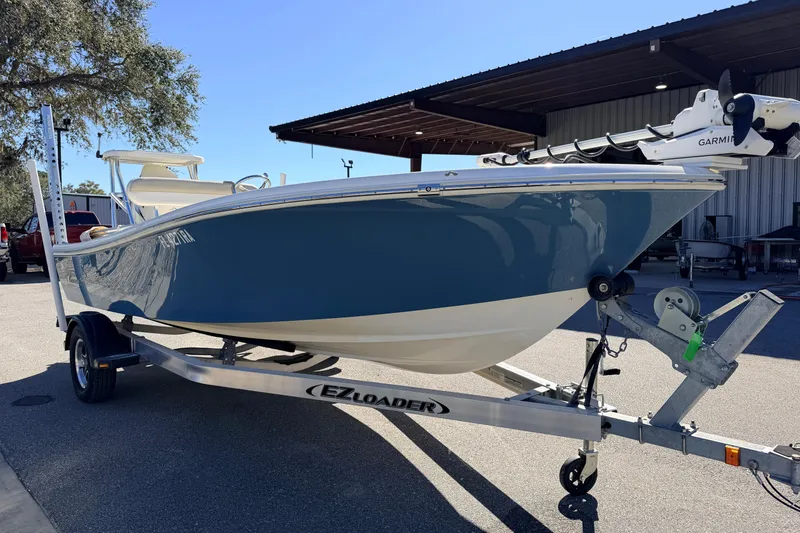 Slide: The Image of 2015 Pioneer 186 Cape Island boat on EZ Loader trailer, parked outdoors. - 5
