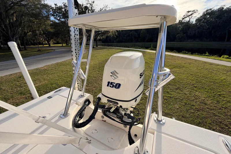 Slide: The Image of 2015 Pioneer 186 Cape Island boat with Suzuki 150 outboard motor, parked on grass. - 52