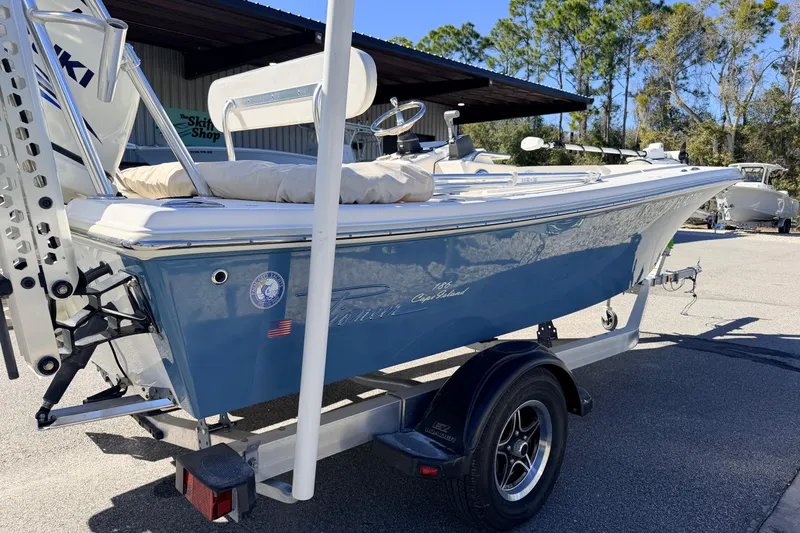 Slide: The Image of 2015 Pioneer 186 Cape Island boat on trailer, parked outdoors near trees. - 6