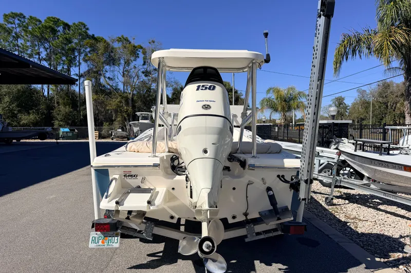 Slide: The Image of 2015 Pioneer 186 Cape Island boat with outboard motor, parked outdoors. - 7