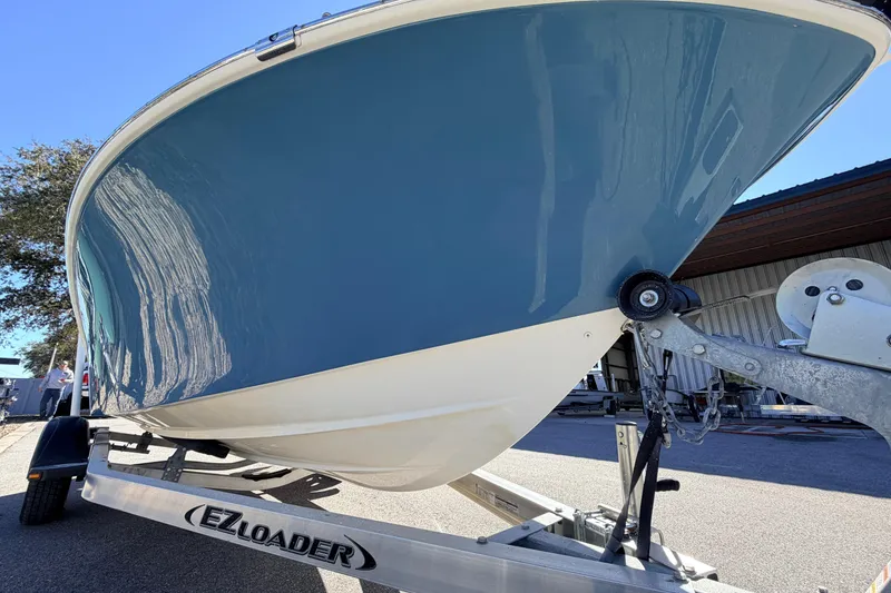 Slide: The Image of 2015 Pioneer 186 Cape Island boat on EZ Loader trailer, blue hull, outdoor setting. - 9