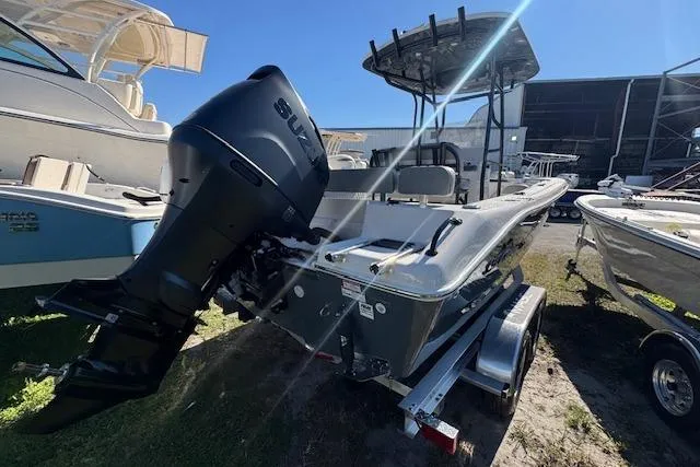 Slide: The Image of 2026 Sea Chaser 22 HFC boat with Suzuki outboard motor, parked on a trailer. - 14