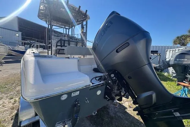 Slide: The Image of 2026 Sea Chaser 22 HFC boat with powerful outboard motor in a sunny marina. - 15