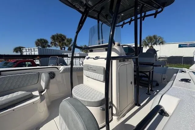 Slide: The Image of 2026 Sea Chaser 22 HFC boat interior with seating and console, under clear blue sky. - 3