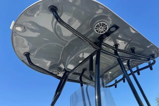 Slide: The Image of 2026 Sea Chaser 22 HFC boat T-top with speakers against clear blue sky. - 4