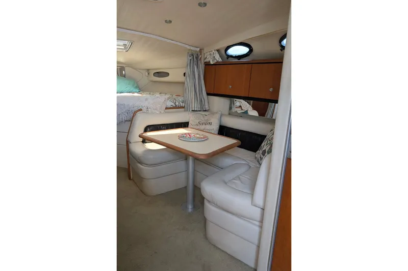 Slide: The Image of 1998 Wellcraft 3600 Martinique cabin interior with dining area and seating. - 10
