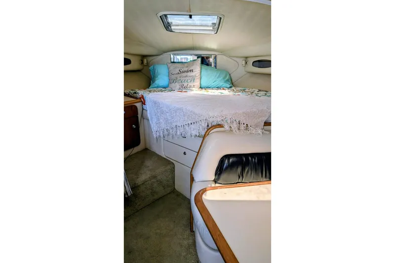 Slide: The Image of 1998 Wellcraft 3600 Martinique cabin interior with cozy bed and decorative pillows. - 11