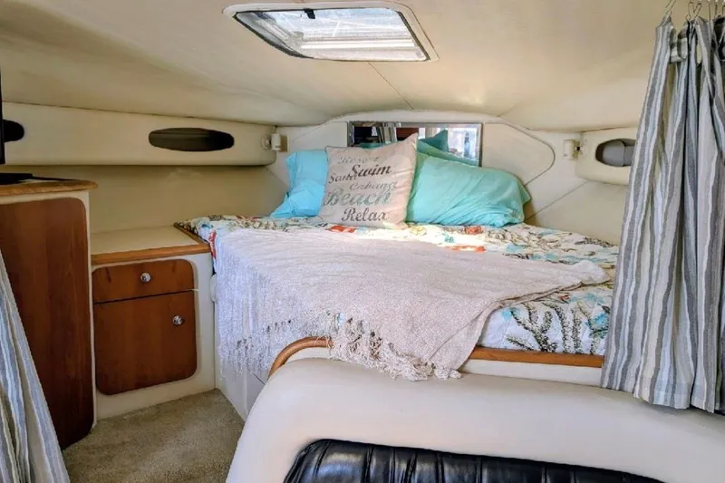 Slide: The Image of 1998 Wellcraft 3600 Martinique cabin interior with cozy bed and nautical decor. - 12
