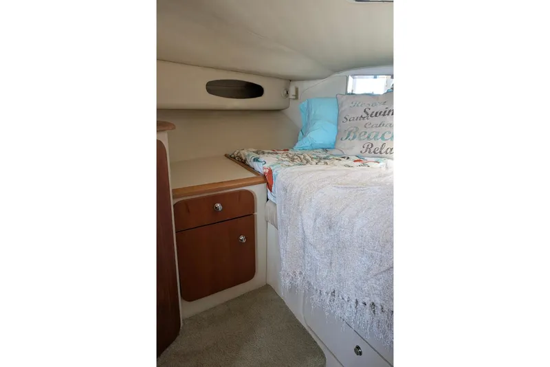 Slide: The Image of Cozy cabin interior of 1998 Wellcraft 3600 Martinique with bed and storage cabinets. - 13