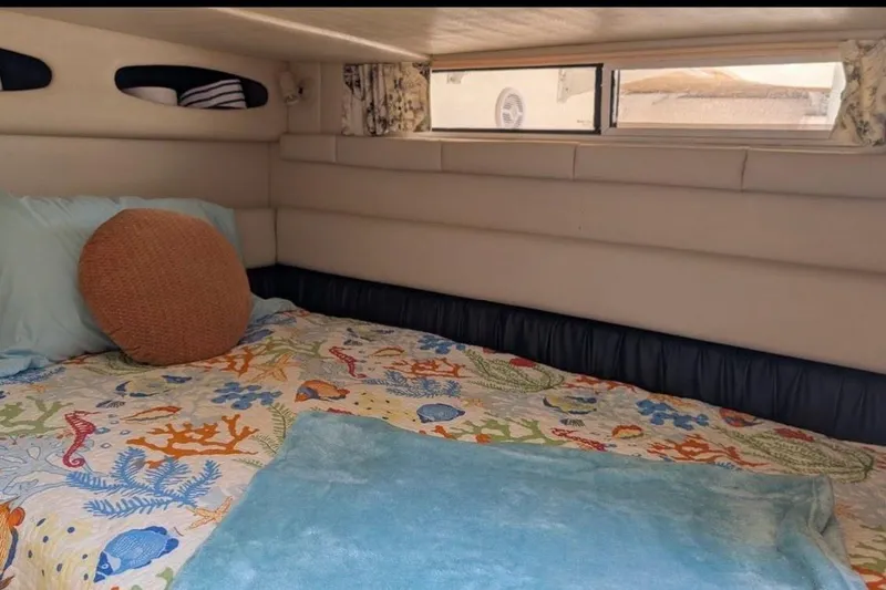 Slide: The Image of Cozy cabin interior of 1998 Wellcraft 3600 Martinique with colorful bedding and window view. - 14