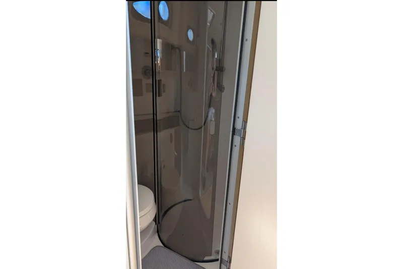 Slide: The Image of Bathroom interior of 1998 Wellcraft 3600 Martinique yacht, featuring shower and toilet. - 16