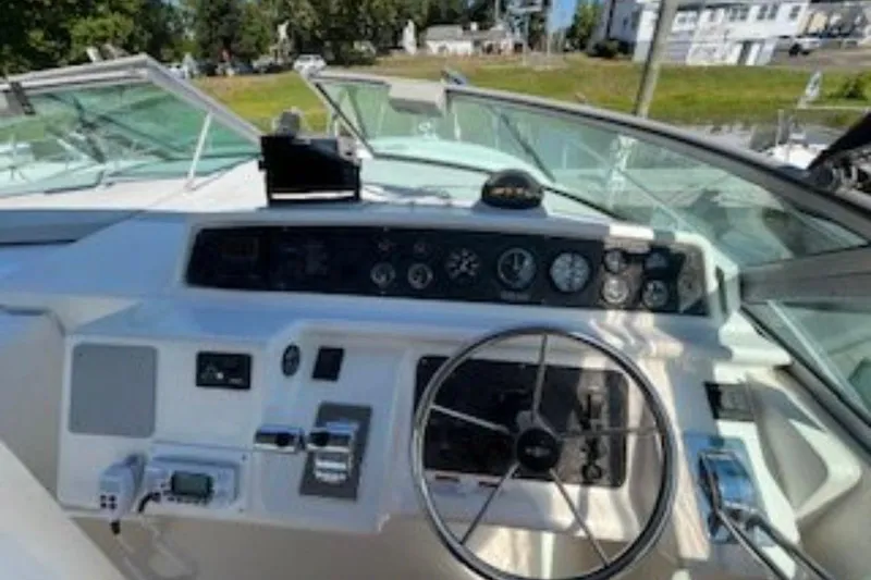 Slide: The Image of 1998 Wellcraft 3600 Martinique boat dashboard with steering wheel and control panel. - 3