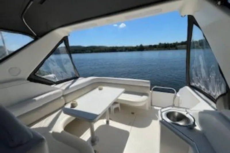 Slide: The Image of Interior view of 1998 Wellcraft 3600 Martinique yacht with lake backdrop. - 4