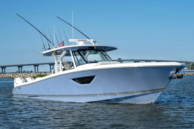 Slide: The Image of Manufacturer Provided Image: 2025 Pursuit S 428 Sport boat cruising on water, clear blue sky background. - 4