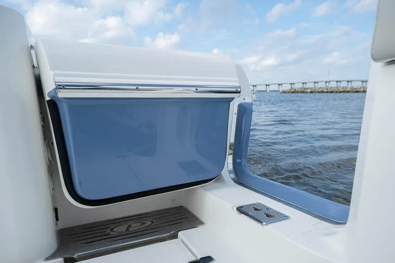 Slide: The Image of Manufacturer Provided Image: 2025 Pursuit S 428 Sport boat interior with ocean view and bridge in background. - 5
