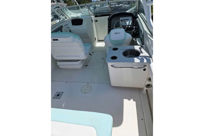 Slide: The Image of 2019 Robalo R247 Dual Console boat interior with seating and sink. - 10