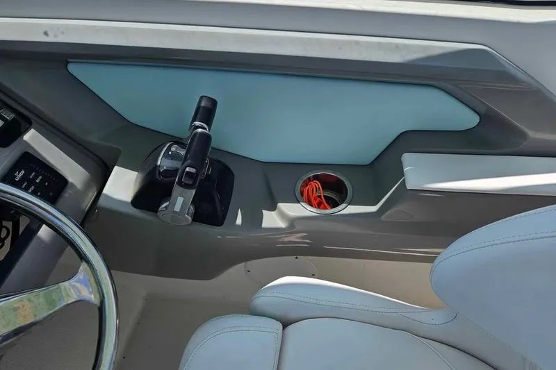 Slide: The Image of 2019 Robalo R247 Dual Console boat interior with steering wheel and throttle controls. - 13