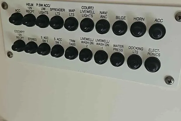 Slide: The Image of Control panel of a 2019 Robalo R247 Dual Console boat with labeled switches. - 14
